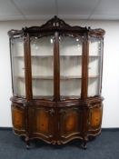 A shaped Italianate four door display cabinet