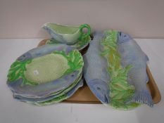A Melba ware salmon serving plate, together with six dinner plates,