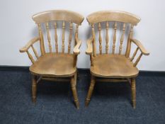 A pair of pine carver armchairs
