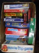 A box containing vintage board games, including Mouse Trap, Game of Life,