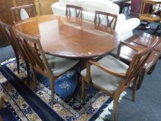 An oval G plan extending dining table with six chairs, two carvers, four singles,