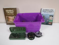 A box containing assorted fly wheels, spools,