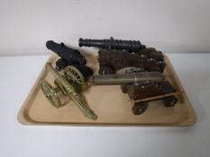 A tray containing four ornamental cannons
