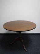 A Georgian and later oak tilt top pedestal table