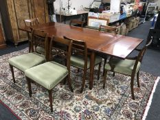 A good quality reproduction mahogany extending dining table with eight chairs, two carvers,