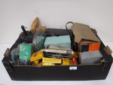 A box containing assorted projectors, slides, film reels,