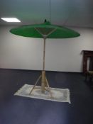 A bamboo Oriental style garden parasol on stand