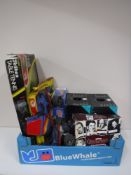 A box containing vintage board games, roller skates, bicycle helmets,