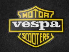 A hand painted Vespa motorcycles advertisement on board