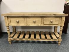 A reclaimed pine three drawer side table,