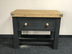 A reclaimed pine butchers block fitted a drawer on a painted base