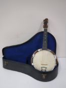 A walnut backed banjo in case,