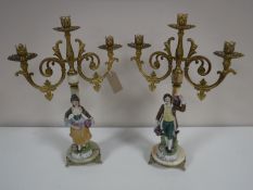 A pair of gilt and onyx three-way table candelabra