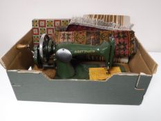 A box containing two upholstered footstools,