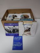Two boxes containing wall plates and books relating to trains together with two wall hangings