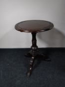 A Victorian style mahogany wine table on three way pedestal