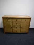 A contemporary pine and wicker sideboard