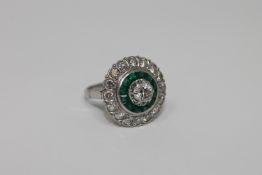 An emerald and diamond cluster ring,