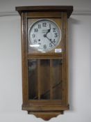 An early twentieth century oak cased wall clock,