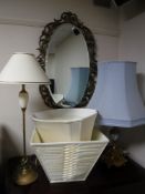 An early 20th century framed bevel edged mirror together with a gilt metal and china table lamp and
