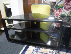 A contemporary black glass corner TV stand
