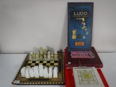 A chess board with onyx chess pieces,