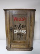 A small antique hanging oak corner cupboard bearing Wills Cigarette advertisement