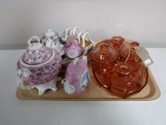 A tray containing a six piece coloured glass trinket set,