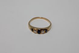 An 18ct gold diamond and sapphire ring, size L, 2.5g.