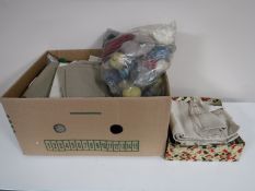 Two boxes containing vintage linen and clothing,