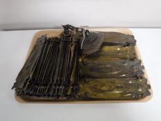 A tray consisting of approximately forty brass finger plates,