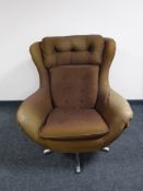 A mid 20th century swivel armchair on chrome base