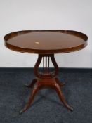 A mahogany pedestal occasional table with gallery