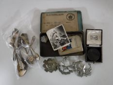 A small collection of EPNS tea spoons, some with enamelled decoration,