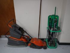 Two Flymo electric lawnmowers, together with a plastic bin stand,