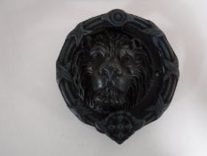 A cast metal lions head door knocker
