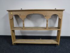 A pine wall mounted plate rack