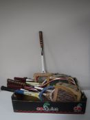 A box of tennis rackets, walking stick,