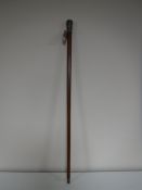 A walking stick with an Eastern white metal pommel