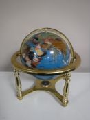 A gemstone globe on stand