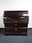 An early 20th century barrel fronted bureau
