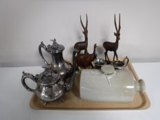 A tray containing a four piece plated tea service, stoneware hot water bottle,