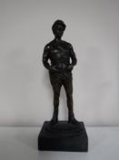 A modern bronze figure on marble base of a builder