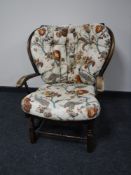 A mid twentieth century armchair upholstered in a floral button fabric