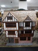 A Georgian style doll's house and a box of doll's house furniture