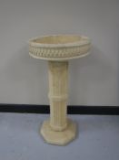 A composition column bird bath