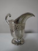 A sterling silver jug, Birmingham hallmarks,