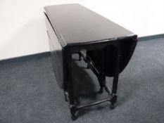 An oak gate leg table fitted a drawer