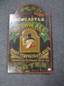 A wooden Newcastle Brown Ale wall sign