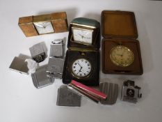A box containing four cased travel clocks,